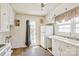 View of the kitchen with white cabinets, a sink, and a door to the exterior at 1435 W Ridge Rd, Salisbury, NC 28147