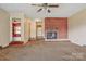 Open living room featuring a brick fireplace and neutral carpeting at 1435 W Ridge Rd, Salisbury, NC 28147