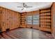 Living room with wood paneled walls, hardwood floors, built-in shelving and a ceiling fan at 1435 W Ridge Rd, Salisbury, NC 28147