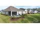 The covered patio boasts cozy blue seating, a grill, and manicured landscaping to give a relaxing outdoor space at 14531 Crosswater Ln, Charlotte, NC 28278