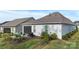 Backyard with covered patio, furniture, and lush landscaping, creating a relaxing retreat at 14531 Crosswater Ln, Charlotte, NC 28278
