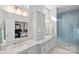 Stylish bathroom featuring dual vanities with granite countertops and a glass shower at 14531 Crosswater Ln, Charlotte, NC 28278