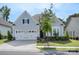 Inviting single-Gathering home featuring a well-manicured lawn and an attached two-car garage at 14531 Crosswater Ln, Charlotte, NC 28278