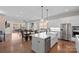 Bright, open-concept kitchen with island, stainless steel appliances, and hardwood floors at 14531 Crosswater Ln, Charlotte, NC 28278