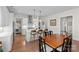 Bright kitchen features an island with bar stool seating and open access to the dining area with wood table at 14531 Crosswater Ln, Charlotte, NC 28278