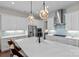 Bright kitchen features stainless appliances, a large island, modern lighting, and light blue glass tile backsplash at 14531 Crosswater Ln, Charlotte, NC 28278