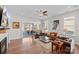 Spacious living room featuring hardwood floors, a ceiling fan, sliding doors to the outside, and comfortable seating at 14531 Crosswater Ln, Charlotte, NC 28278