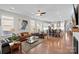 Open-concept living room with hardwood floors leads to the kitchen and dining area, offering a modern and airy space at 14531 Crosswater Ln, Charlotte, NC 28278
