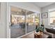 Bright living room view to covered patio with ceiling fan and outdoor seating at 14531 Crosswater Ln, Charlotte, NC 28278