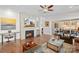 Comfortable living room features a fireplace, TV, hardwood floors, and sliding glass doors to the backyard patio at 14531 Crosswater Ln, Charlotte, NC 28278