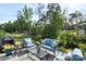 The patio offers a wooded view and comfortable blue seating around a glass table, perfect for outdoor enjoyment at 14531 Crosswater Ln, Charlotte, NC 28278