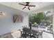 The covered patio boasts an outdoor dining area, a ceiling fan, and overlooks comfortable seating for relaxation at 14531 Crosswater Ln, Charlotte, NC 28278