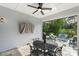 The covered patio boasts an outdoor dining area, a ceiling fan, and overlooks comfortable seating for relaxation at 14531 Crosswater Ln, Charlotte, NC 28278