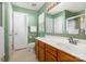 Well-lit bathroom with a wooden vanity, white countertop, neutral tile flooring and a shower stall at 1533 Moss Creek Dr, Harrisburg, NC 28075