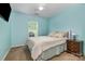 Inviting bedroom with a calm blue palette, a comfortable bed, and a bright window with natural light at 1533 Moss Creek Dr, Harrisburg, NC 28075