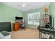 Bright bedroom featuring a large window, computer desk, carpet floors and a ceiling fan at 1533 Moss Creek Dr, Harrisburg, NC 28075