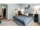 Relaxing bedroom showcasing a neutral color scheme, plush carpet, and a decorative wall painting at 1533 Moss Creek Dr, Harrisburg, NC 28075