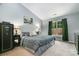 Comfortable bedroom with neutral walls, soft carpet, natural light, and a decorative accent painting at 1533 Moss Creek Dr, Harrisburg, NC 28075