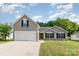 Charming gray home featuring a two-car garage and a well-manicured front lawn at 1533 Moss Creek Dr, Harrisburg, NC 28075