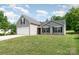Well-maintained home boasts a two-car garage, complemented by a lush, green front lawn at 1533 Moss Creek Dr, Harrisburg, NC 28075