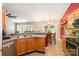 Cozy kitchen featuring wood cabinets, neutral countertops, stainless steel appliances, and tile floors at 1533 Moss Creek Dr, Harrisburg, NC 28075