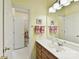 Bright bathroom with a white sink, wooden vanity, mirror, and a separate toilet and shower area at 15929 Northstone Dr, Huntersville, NC 28078