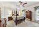 Main bedroom featuring a ceiling fan, four-poster bed, and bedside tables at 15929 Northstone Dr, Huntersville, NC 28078