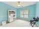 Well-lit bedroom featuring blue walls, white trim, study desk, chair and white carpeting at 15929 Northstone Dr, Huntersville, NC 28078