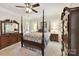 Well decorated bedroom featuring a ceiling fan, four-poster bed, and a dresser at 15929 Northstone Dr, Huntersville, NC 28078