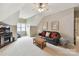 Bright bonus room with a vaulted ceiling, comfortable leather sofa, and a wooden coffee table at 15929 Northstone Dr, Huntersville, NC 28078