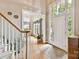 Bright foyer featuring hardwood floors, large windows, and an open entryway to other living spaces at 15929 Northstone Dr, Huntersville, NC 28078