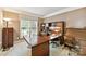 Cozy home office featuring custom built-ins, neutral carpet and paint, and natural light at 15929 Northstone Dr, Huntersville, NC 28078