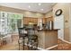 Eat-in kitchen featuring wooden cabinets, a breakfast bar, and stainless steel appliances at 15929 Northstone Dr, Huntersville, NC 28078
