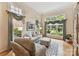 Bright living room features hardwood floors, decorative area rug, and many large windows at 15929 Northstone Dr, Huntersville, NC 28078