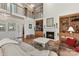 Open-concept living room with high ceilings, fireplace, built-in shelves, and ample natural light at 15929 Northstone Dr, Huntersville, NC 28078