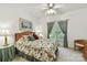 Cozy bedroom with floral bedding, wooden bed frame, side tables, lamps, and natural light from the window at 15929 Northstone Dr, Huntersville, NC 28078