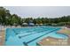 Outdoor swimming pool area featuring a large pool, lounge chairs, umbrellas, and a slide at 15929 Northstone Dr, Huntersville, NC 28078