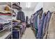 Organized walk-in closet with ample storage space for clothing and accessories on multiple shelves and racks at 15929 Northstone Dr, Huntersville, NC 28078