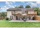 Expansive backyard featuring a second story deck, covered patio, lush lawn, and mature trees at 1621 Brookdale Ave, Charlotte, NC 28210
