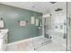 Bathroom featuring seamless glass shower, green accent wall and decor at 1621 Brookdale Ave, Charlotte, NC 28210