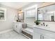 Well-lit bathroom with double sink vanity and a view of the backyard at 1621 Brookdale Ave, Charlotte, NC 28210