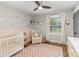 Cozy Bedroom with chair, crib, patterned rug, and natural light at 1621 Brookdale Ave, Charlotte, NC 28210