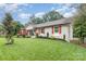 A charming home with lush green lawn, neat garden beds and classic architecture at 1621 Brookdale Ave, Charlotte, NC 28210