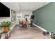 Well-lit home office with a desk, TV, and exercise equipment at 1621 Brookdale Ave, Charlotte, NC 28210