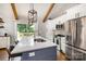 Bright kitchen with a blue island, stainless steel appliances, and deck access at 1621 Brookdale Ave, Charlotte, NC 28210