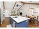 Modern kitchen with a blue island, breakfast bar, and open view to the living areas at 1621 Brookdale Ave, Charlotte, NC 28210