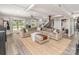 Spacious living room with a plush sectional sofa, ottoman and access to the backyard at 1621 Brookdale Ave, Charlotte, NC 28210