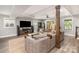 Open living room features a large sectional, ceiling fan, and natural light at 1621 Brookdale Ave, Charlotte, NC 28210