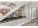 Charming reading nook with a built-in bookshelf under the stairs at 1621 Brookdale Ave, Charlotte, NC 28210