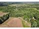 Expansive aerial view of a property surrounded by lush green trees and fields at 169 Wilcox Karriker Ln, Statesville, NC 28625